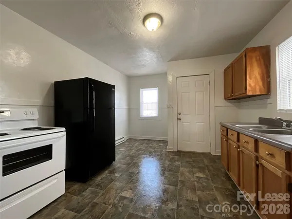 a kitchen with a refrigerator stove and sink