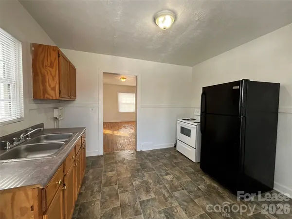 a kitchen with a refrigerator sink and stove