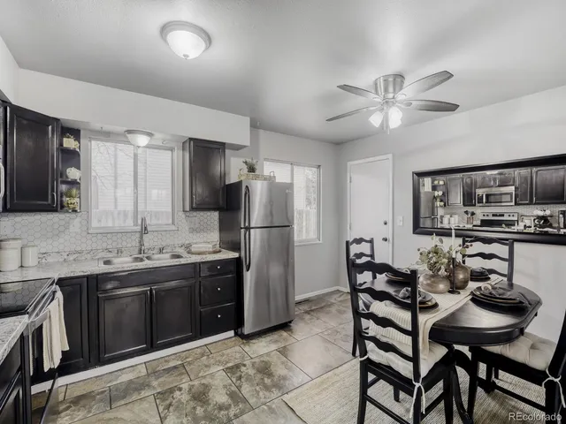a kitchen with stainless steel appliances kitchen island granite countertop a sink and cabinets