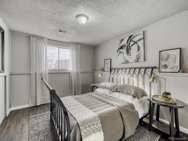 a bedroom with a bed and a table in it