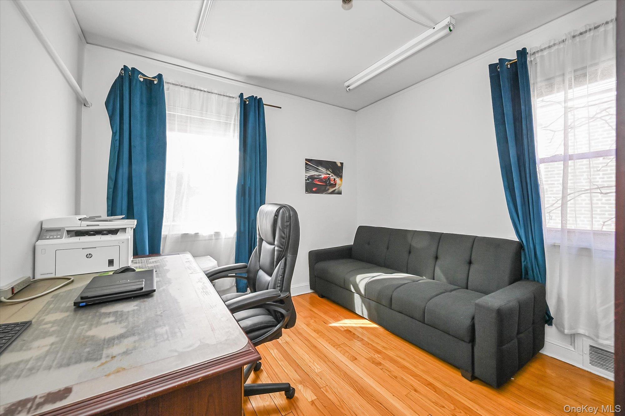 184-32 Cambridge Road Queens, NY 11432 - Photo 13 of 22 a living room with furniture and a window