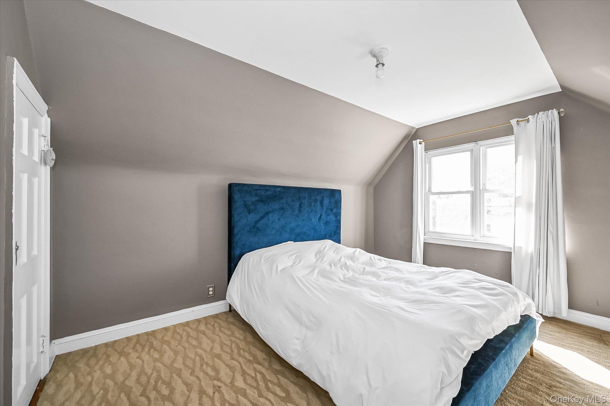 184-32 Cambridge Road Queens, NY 11432 - Photo 16 of 22 a bed sitting in a bedroom next to a window