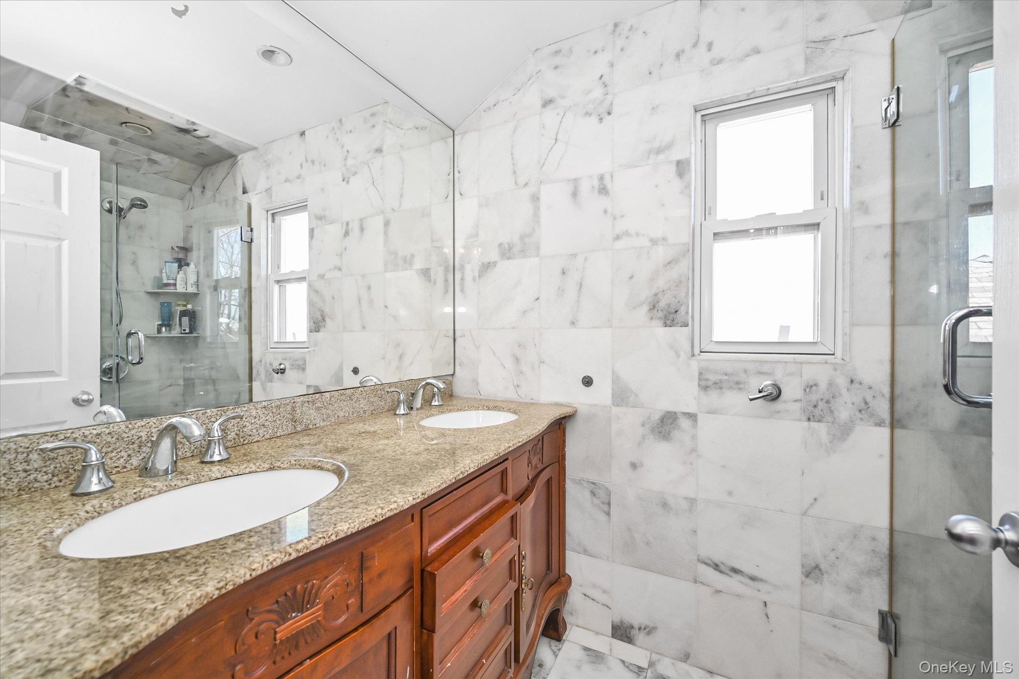 184-32 Cambridge Road Queens, NY 11432 - Photo 17 of 22 a bathroom with a granite countertop sink a mirror and a shower