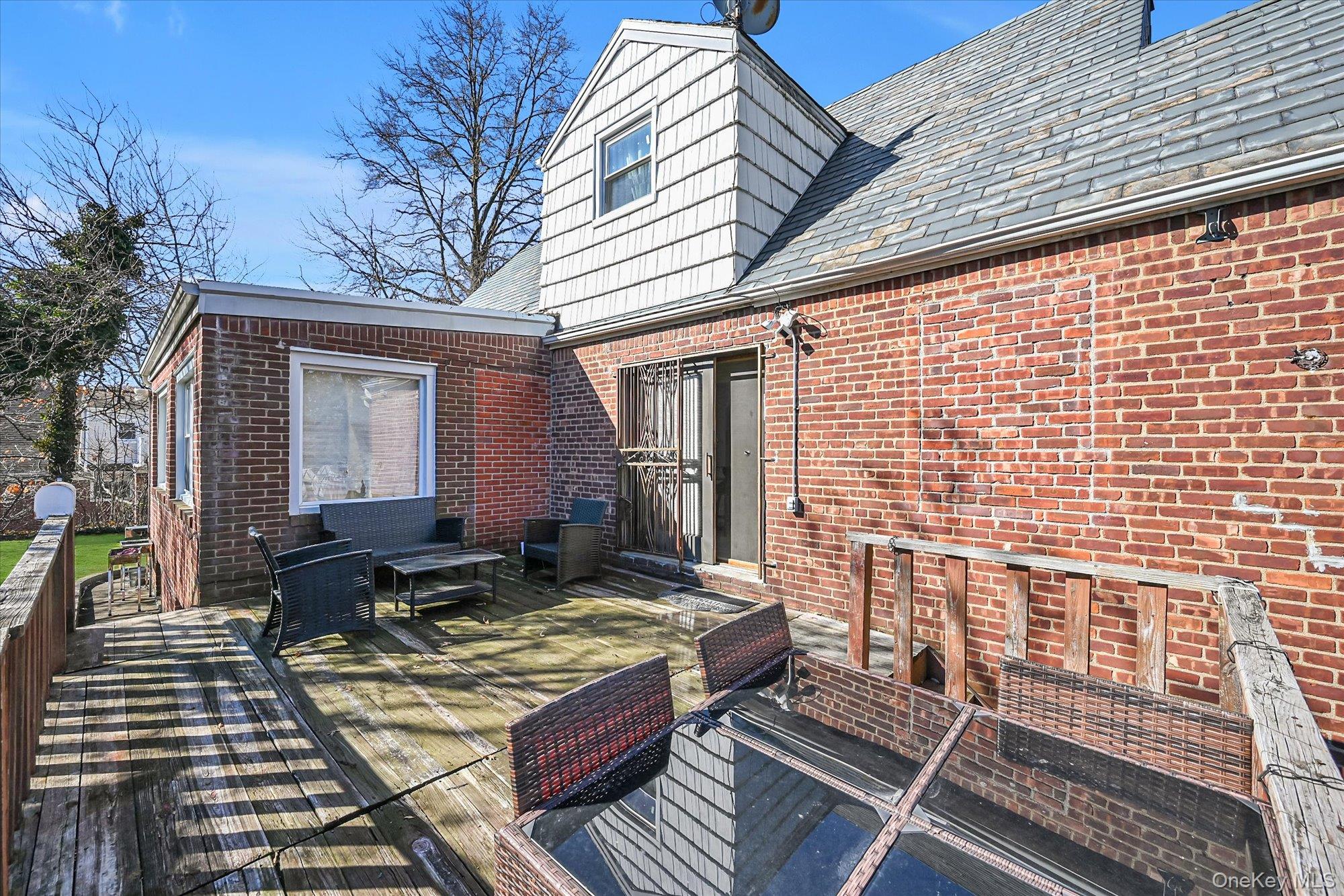 184-32 Cambridge Road Queens, NY 11432 - Photo 19 of 22 a backyard of a house with outdoor seating