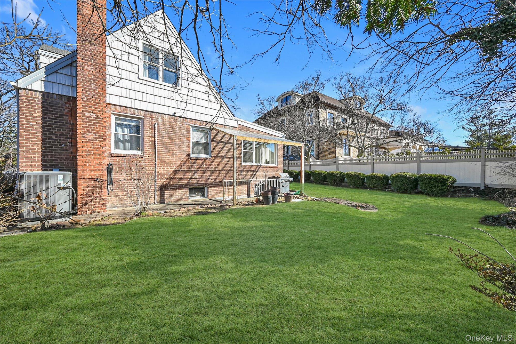 184-32 Cambridge Road Queens, NY 11432 - Photo 20 of 22 a view of a house with a backyard