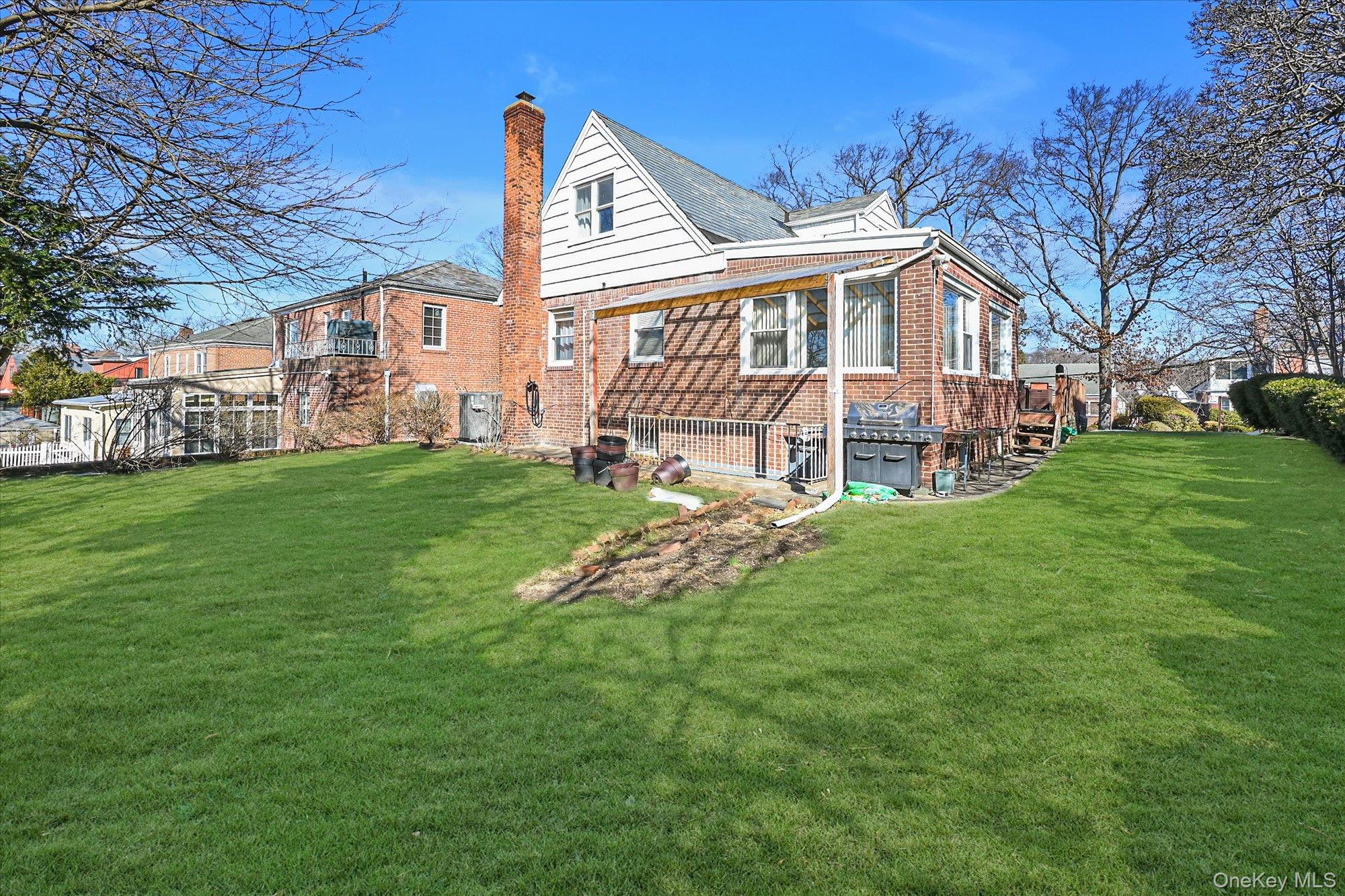 184-32 Cambridge Road Queens, NY 11432 - Photo 2 of 22 a view of a house with a yard