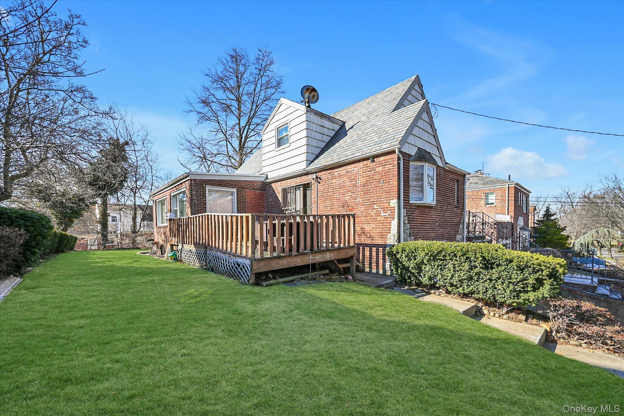184-32 Cambridge Road Queens, NY 11432 - Photo 21 of 22 a view of a house with a yard and deck