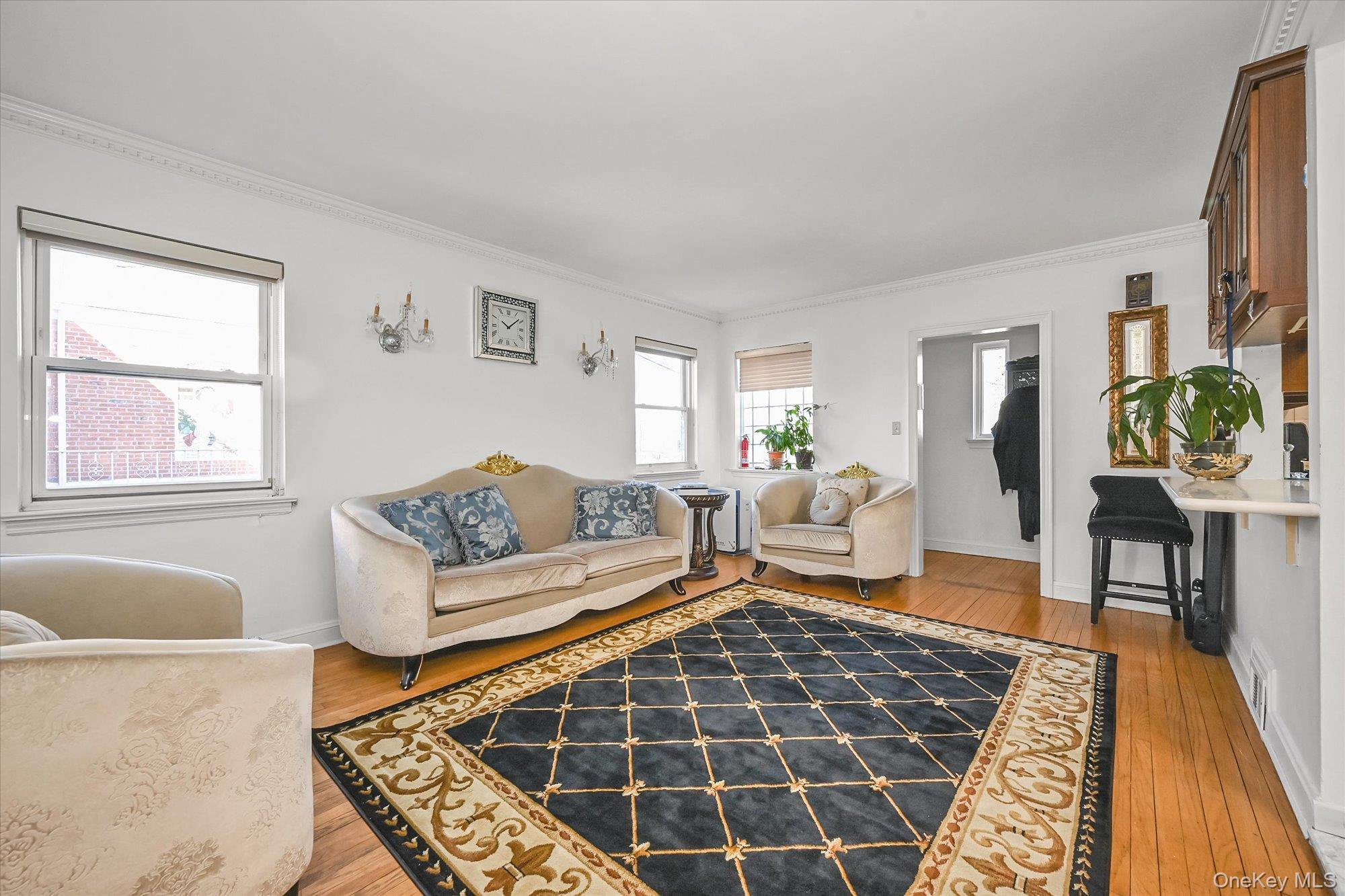 184-32 Cambridge Road Queens, NY 11432 - Photo 3 of 22 a living room with furniture and a rug
