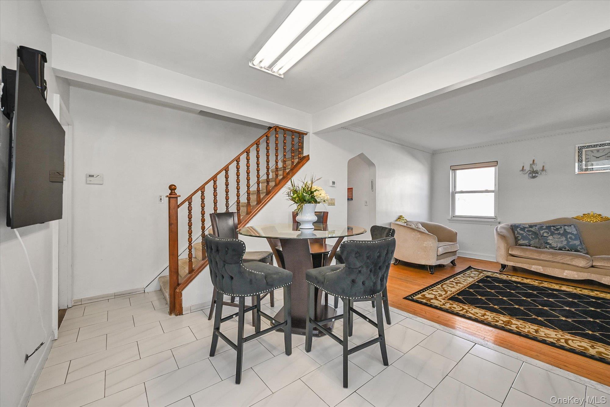 184-32 Cambridge Road Queens, NY 11432 - Photo 6 of 22 a living room with furniture and a dining table