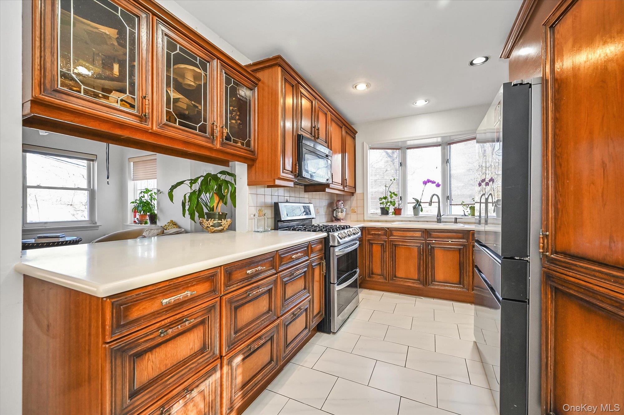 184-32 Cambridge Road Queens, NY 11432 - Photo 10 of 22 a kitchen with stainless steel appliances granite countertop a sink and cabinets