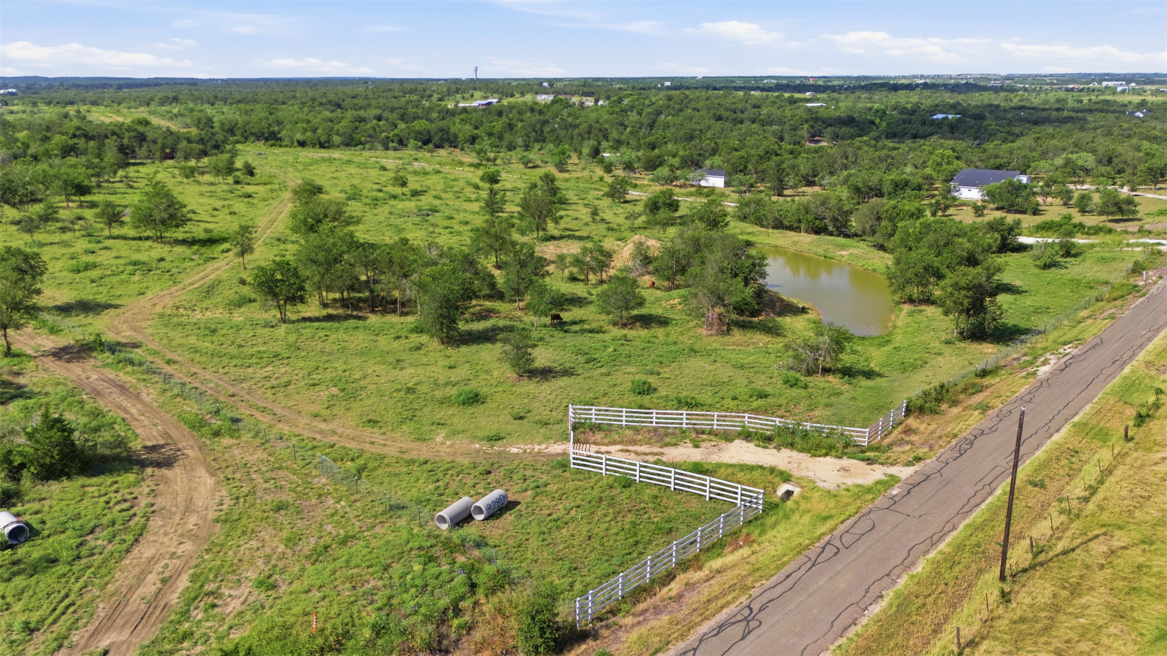 3280 County Road 466 Elgin, TX 78621 - Photo 12 of 13 A sprawling rural lot featuring a private pond and abundant mature trees.
