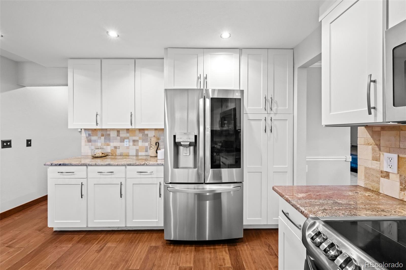 210 South Deframe Way Golden, CO 80401 - Photo 15 of 50 a kitchen with a stove refrigerator and microwave