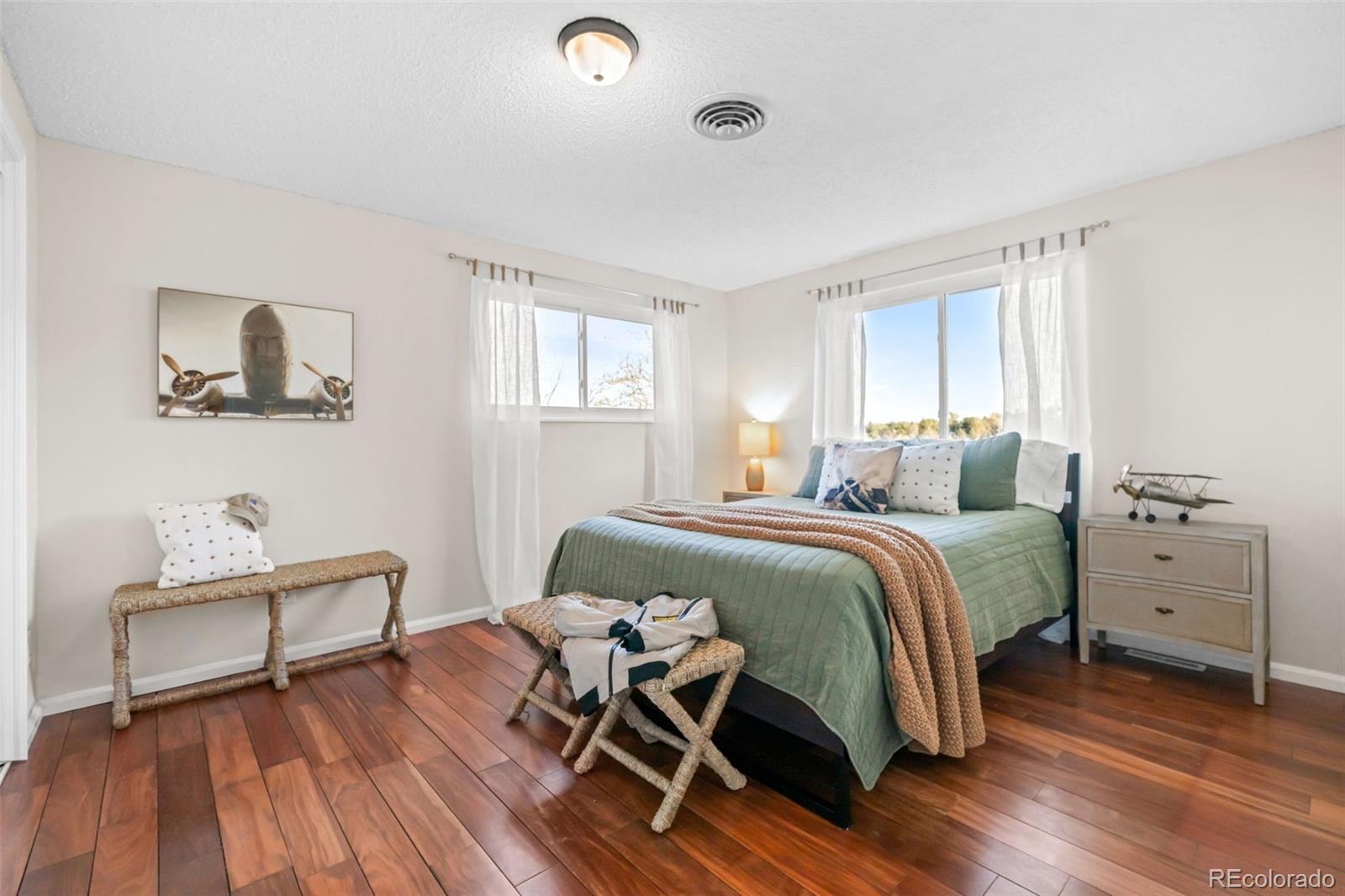 210 South Deframe Way Golden, CO 80401 - Photo 29 of 50 a bedroom with a bed and wooden floor