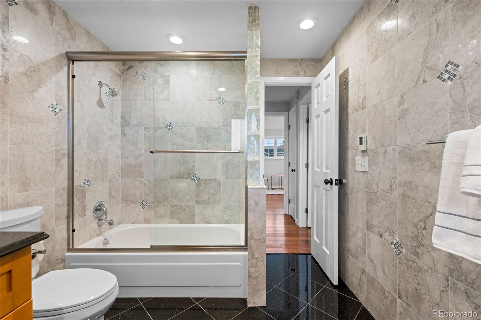 210 South Deframe Way Golden, CO 80401 - Photo 31 of 50 a bathroom with a shower a toilet and a bathtub