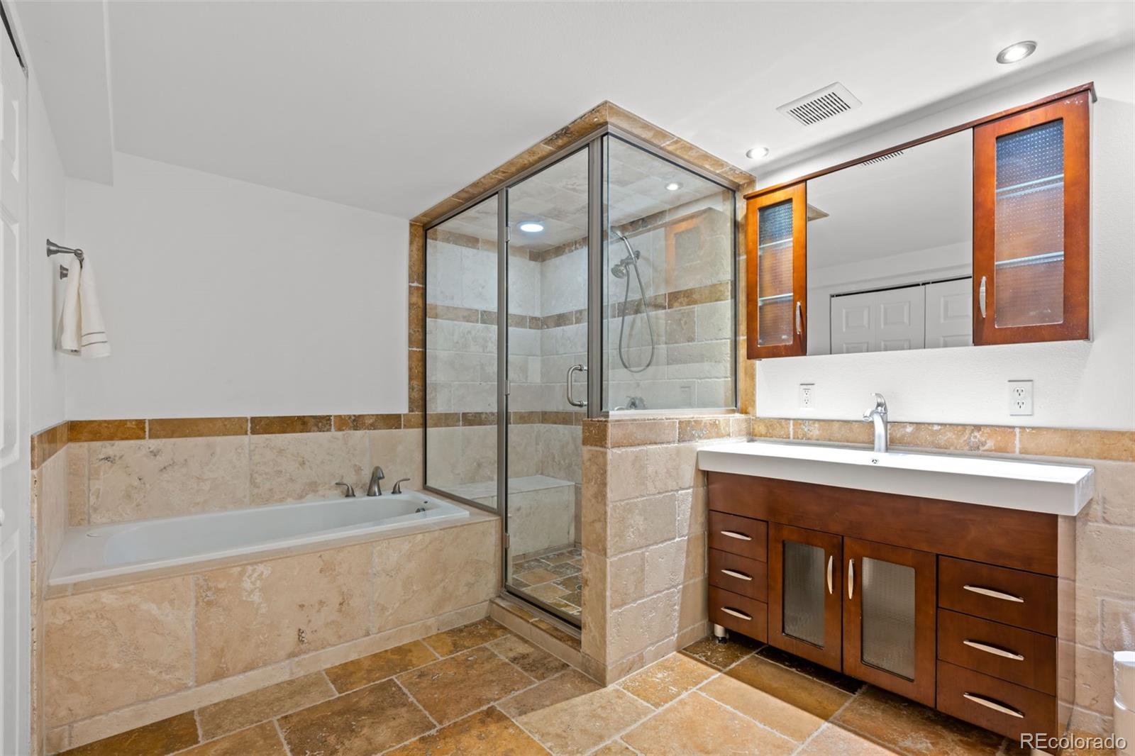 210 South Deframe Way Golden, CO 80401 - Photo 37 of 50 a bathroom with a tub sink and mirror