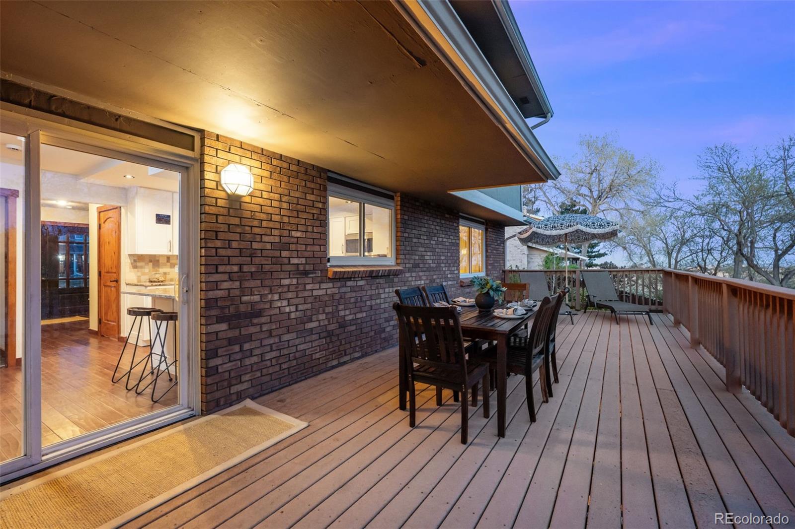 210 South Deframe Way Golden, CO 80401 - Photo 38 of 50 a view of a patio with table and chairs and wooden floor