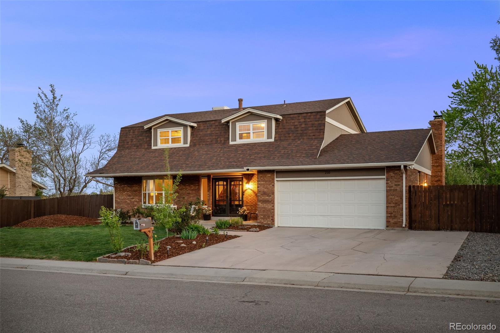 210 South Deframe Way Golden, CO 80401 - Photo 5 of 50 a front view of a house with a yard and garage