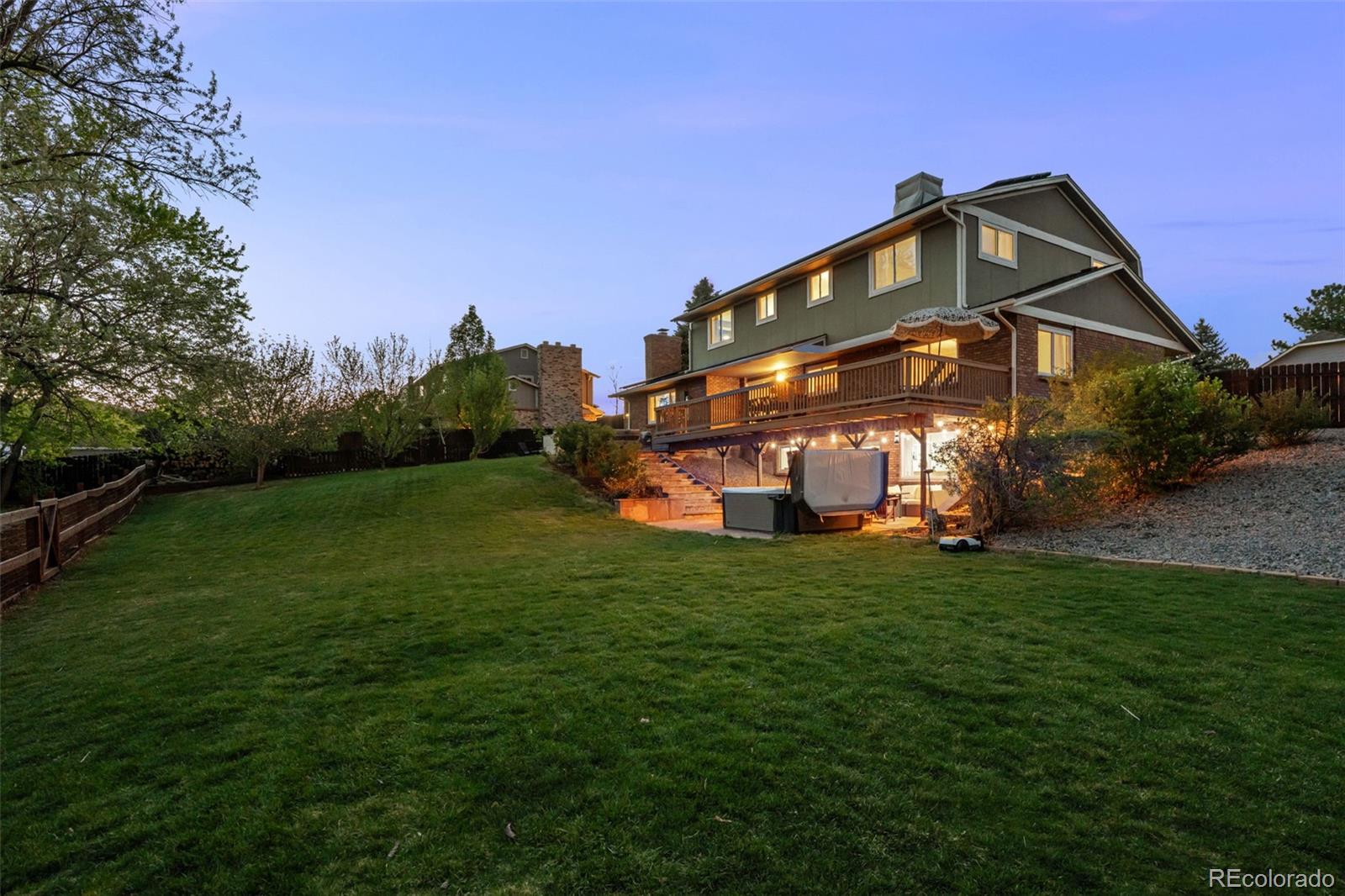 210 South Deframe Way Golden, CO 80401 - Photo 6 of 50 a view of a big house with a big yard and large trees