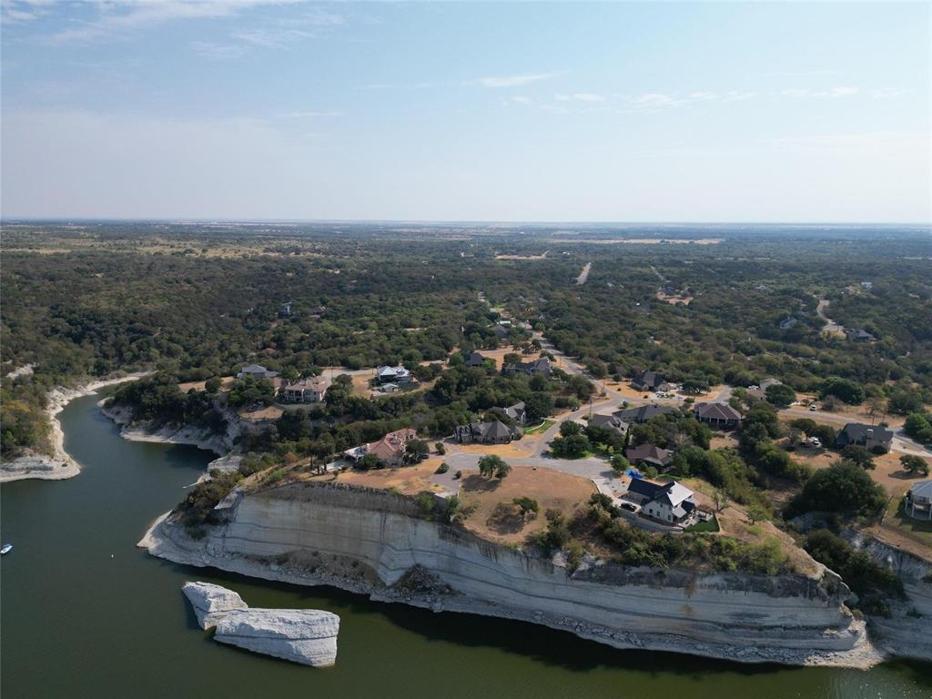 1233 Overlook Court Whitney, TX 76692 - Photo 3 of 34 an aerial view of a residential houses with outdoor space and trees