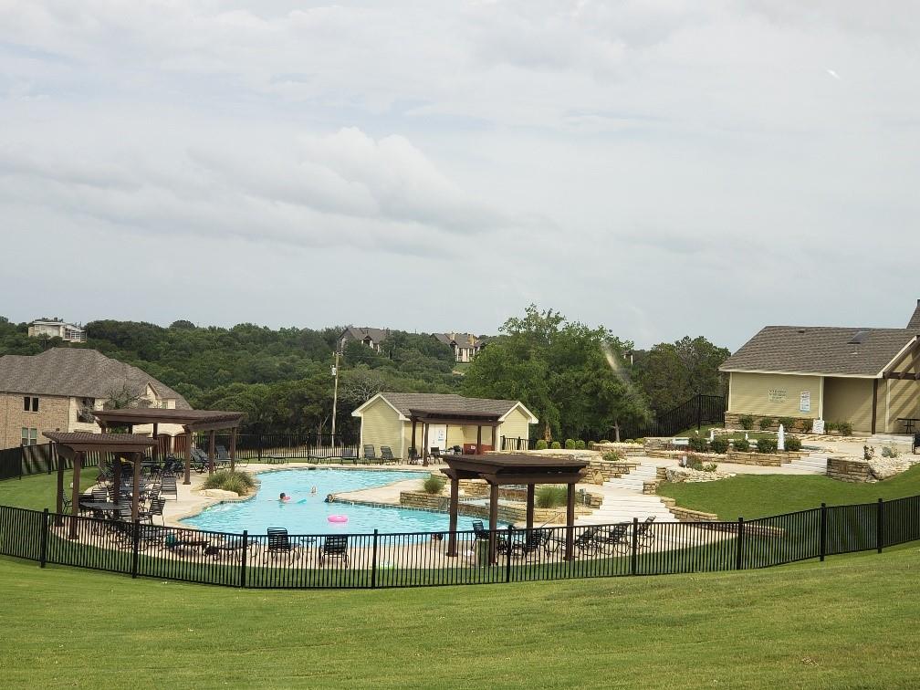 1233 Overlook Court Whitney, TX 76692 - Photo 33 of 34 a view of a swimming pool with lawn chairs and a big yard