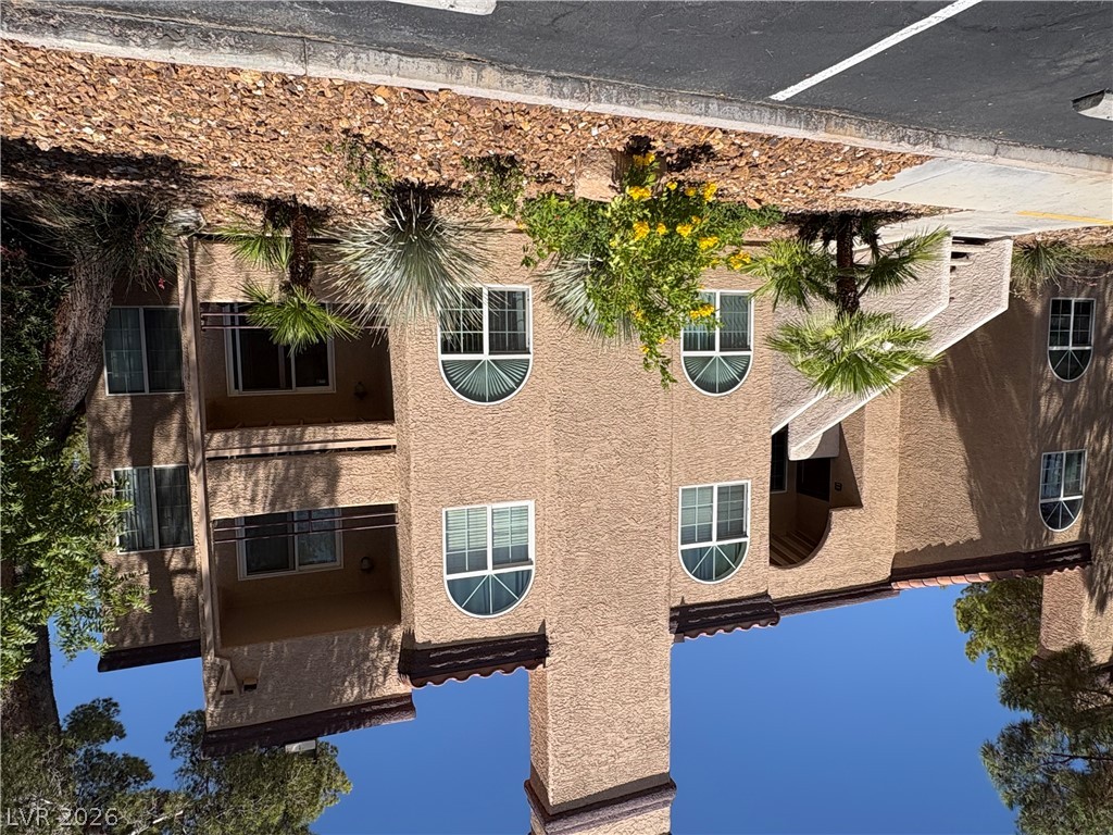 9325 West Desert Inn Road, Unit 123 Las Vegas, NV 89117 - Photo 1 of 36 A well-maintained multi-story building features curved windows and vibrant landscaping.