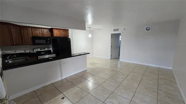 a kitchen with granite countertop a sink and a stove top oven