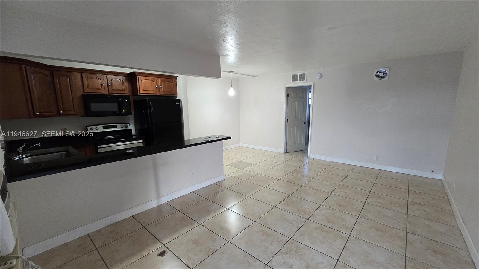 a kitchen with granite countertop a sink and a stove top oven