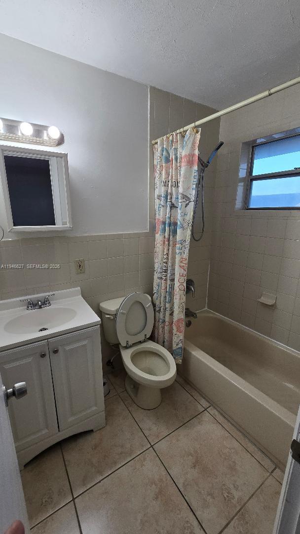 9375 Southwest 40th Terrace, Unit 211 Miami, FL 33165 - Photo 5 of 5 a bathroom with a sink a toilet and shower