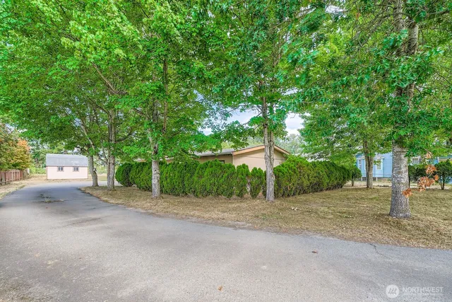 a front view of a house with a street