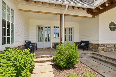 a view of a patio with table and chairs and potted plants