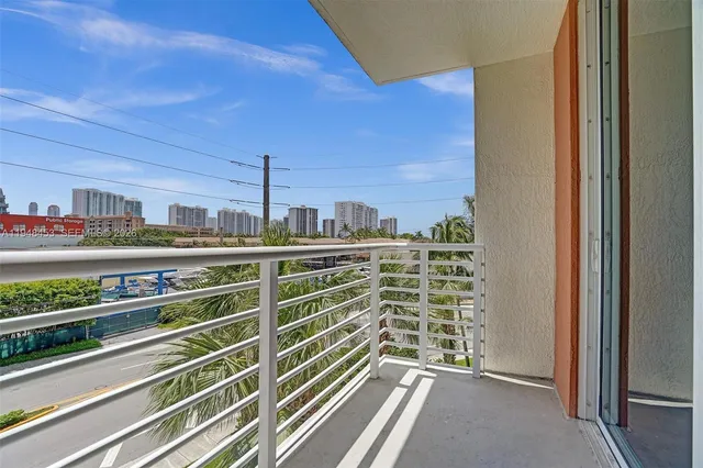 a view of a balcony with wooden floor and windows