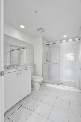 a bathroom with a shower a toilet and sink