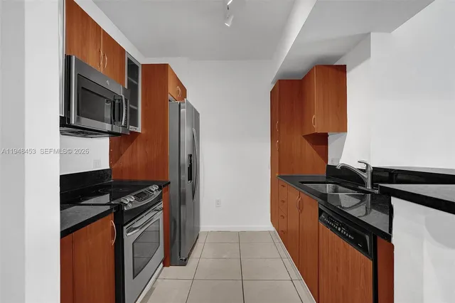 a kitchen with stainless steel appliances granite countertop a stove and a microwave
