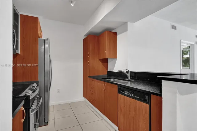 a kitchen with granite countertop a sink and a stove
