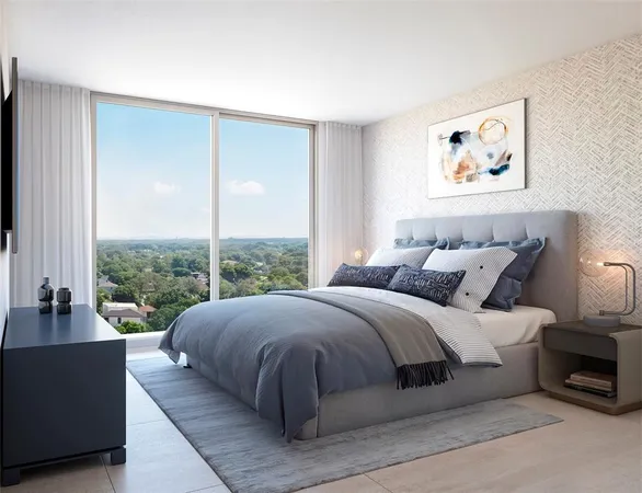 a large bedroom with a bed and a large window