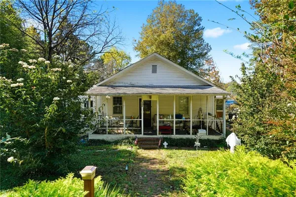 a view of a house with backyard garden and swimming pool