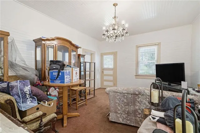 a living room with furniture a piano and a flat screen tv