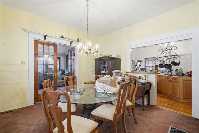 a view of a dining room with furniture and chandelier