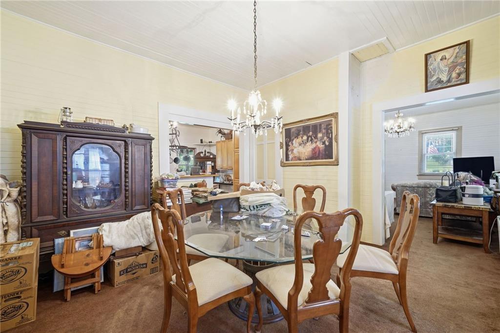348 Old Tate Road Jasper, GA 30143 - Photo 18 of 35 a dining room with furniture a chandelier and wooden floor