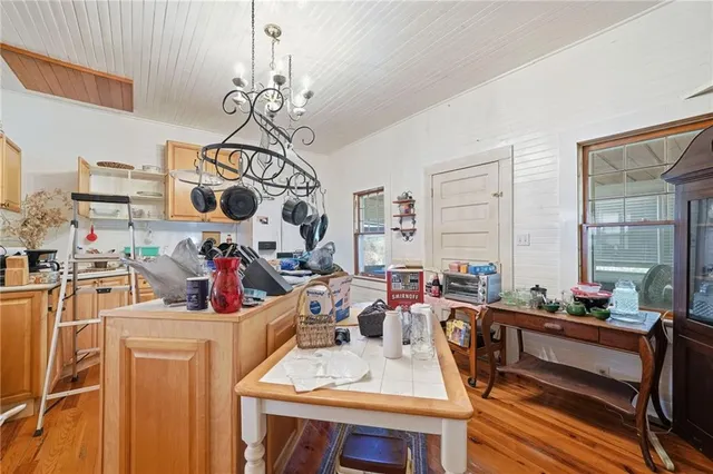 a view of a dining hall with couches and a dining table with dishwasher