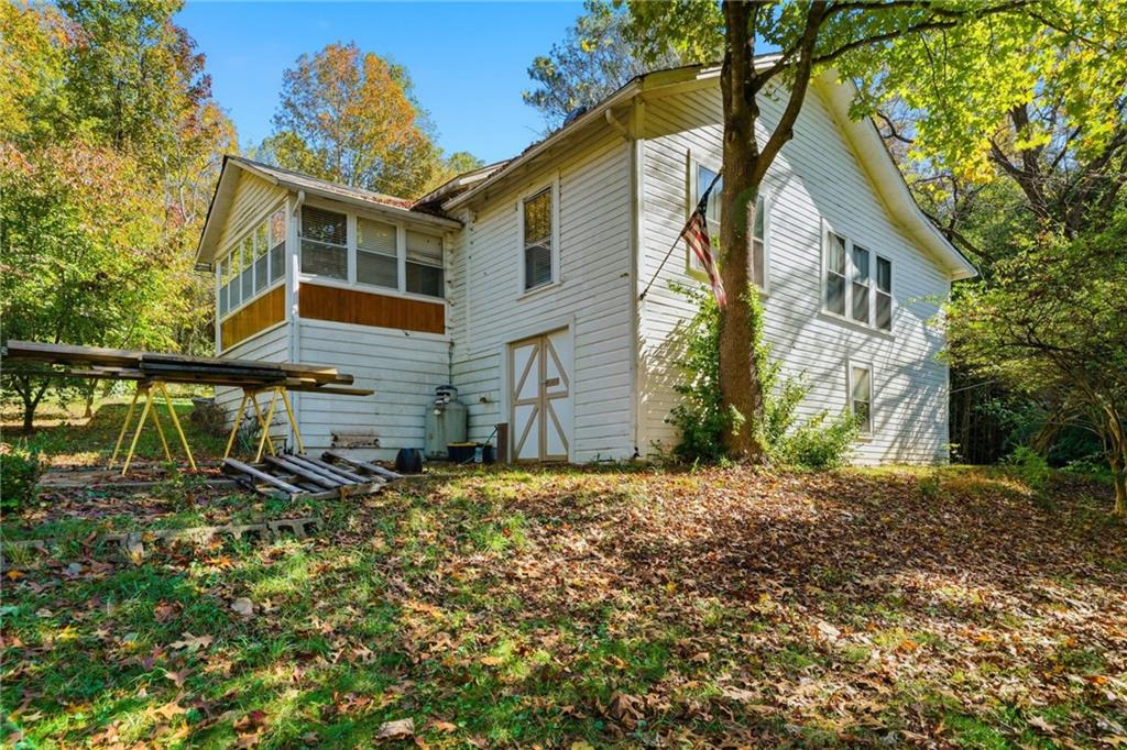 348 Old Tate Road Jasper, GA 30143 - Photo 33 of 35 a backyard of a house with large trees and barbeque oven
