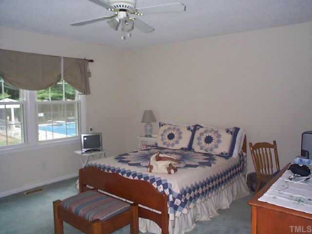5412 Live Oak Trail Raleigh, NC 27613 - Photo 9 of 10 a bedroom with a bed and wooden floor