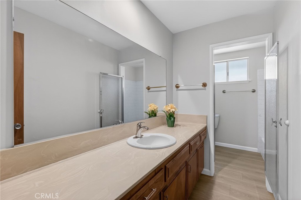 4963 Carlingford Avenue Riverside, CA 92504 - Photo 20 of 33 a bathroom with a granite countertop sink and a mirror