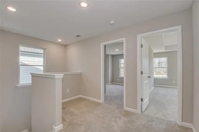 an empty room with windows and closet