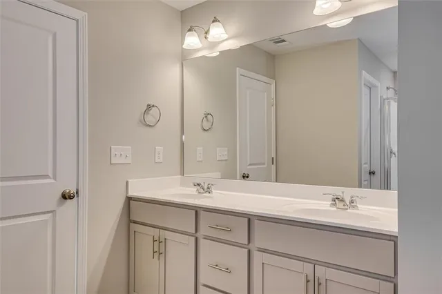 a bathroom with 2 sink and a mirror