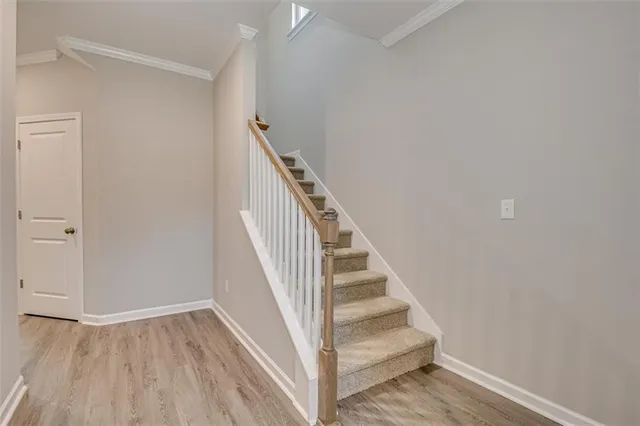 a view of entryway and hall with wooden floor