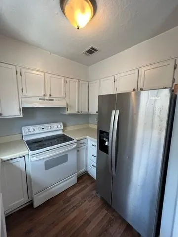 a kitchen with a refrigerator sink and stove
