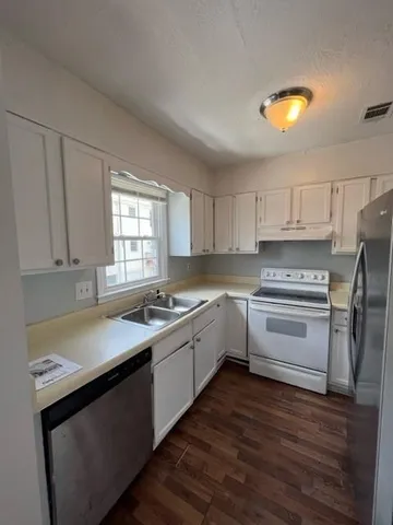 a kitchen with a sink stove and cabinets