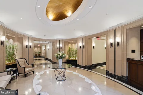 a living room with furniture and floor to ceiling window