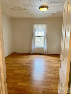 a view of a livingroom with wooden floor and window